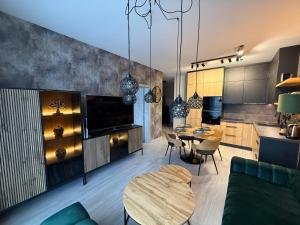 a kitchen and a living room with a table and a dining room at Apartmán Lottner in Kysucké Nové Mesto