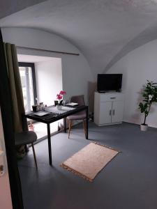 a living room with a table and a television at Ubytovanie Čadca in Čadca