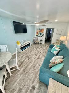 a living room with a blue couch and a table at Malibu Resort Motel in St Pete Beach