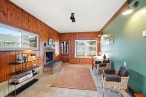 a living room with wooden walls and a fireplace at The Stoop On Spencer Drive in Van Wert