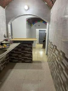 a kitchen with a counter and a person in a room at منزل نوبي إضافة in Aswan