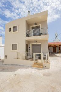 a white house with balconies on the side of it at Marizaf house in Émbonas