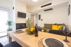 a living room with a table with a bottle of wine at Marizaf house in Émbonas