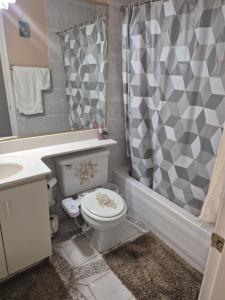 a bathroom with a toilet and a sink and a shower at Enjoy Life in Heart of North Delta in Delta +7 photos