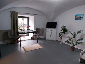 a living room with a table and a television at Ubytovanie Čadca in Čadca