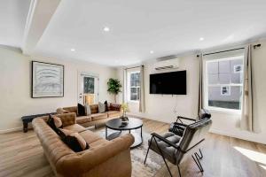 a living room with a couch and chairs and a tv at Elegant 2Story Bloomfield 3 Kings 2 Queens in Bloomfield +40 photos