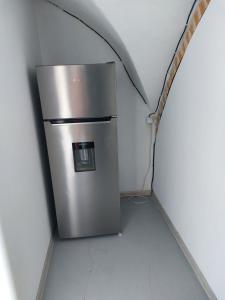 a stainless steel refrigerator in a room with a tunnel at Ubytovanie Čadca in Čadca +1 photo
