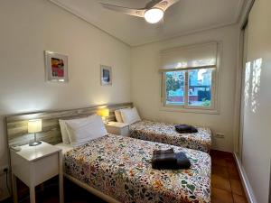 a bedroom with two beds and a window at Villa Alegre - 2 bed villa with private heated pool on Mar Menor Golf - family friendly in Torre-Pacheco +23 photos