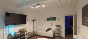 a living room with a bed and a flat screen tv at Il sogno di Elisa in Parma