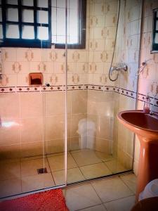 a shower with a glass door next to a sink at La Casa de Don Lucho - Santa Cruz in Santa Cruz de la Sierra
