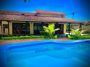 a house with a swimming pool in front of it at La Casa de Don Lucho - Santa Cruz in Santa Cruz de la Sierra +18 photos