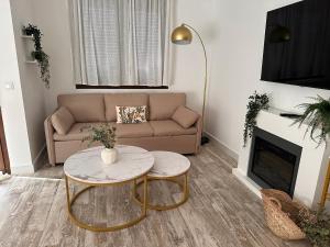 a living room with a couch and a table at Apartamentos Consuegra frente a los molinos in Consuegra