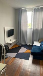 a living room with a bed and a television at Espaço do Adilson em Paciência RJ in Rio de Janeiro +30 photos