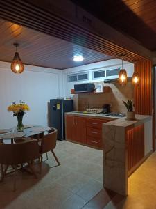 a kitchen and dining room with a table and a refrigerator at INTI & QUILLA Appartments in Sibundoy
