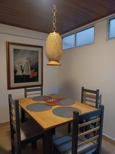 a dining room with a wooden table with chairs at INTI & QUILLA Appartments in Sibundoy