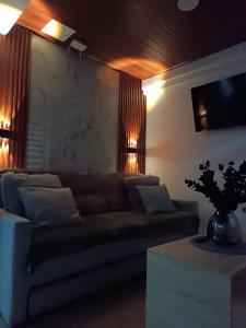 a living room with a couch and a table at INTI & QUILLA Appartments in Sibundoy