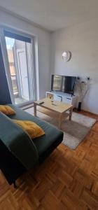 a living room with a couch and a table at Cozy & Fully Equipped Flat in a Prime Location in Essen