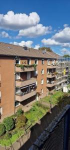 an apartment building with grass on the side of it at Cozy & Fully Equipped Flat in a Prime Location in Essen