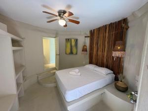 a bedroom with a bed and a ceiling fan at MK BEACH Playa Del Carmen in Playa del Carmen