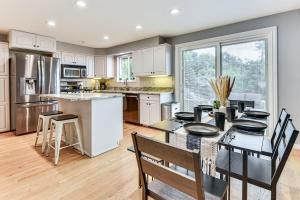 a kitchen with white cabinets and a table with chairs at Mountain-View Retreat with Hot Tub in Centerville! in Centerville