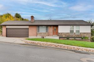 a brick house with a garage on a street at Mountain-View Retreat with Hot Tub in Centerville! in Centerville