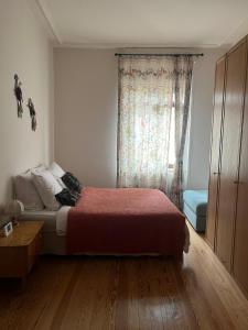 a bedroom with a bed and a window at Apparemment de style 70s in Colmar +14 photos
