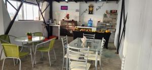 a dining room with a glass table and chairs at Pacasmayo Surf Las Torres in Pacasmayo