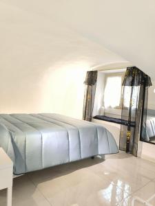 a white bed in a room with a window at La Nica in Catania +3 photos