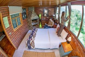 a man and woman standing in a bedroom in a tiny house at La Casa del Molino Blanco B&B in Baños