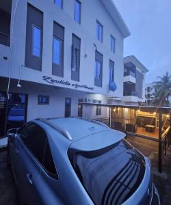 a blue car parked in front of a building at Zendidisluxuryapartments in Lekki