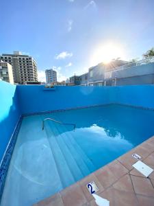 a blue swimming pool on top of a building at Condado Serenity by the Sea in San Juan