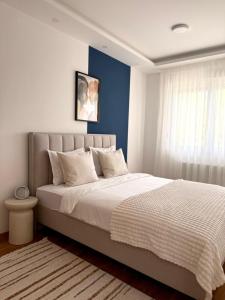 a bedroom with a large bed and a window at Stan na dan Bogdan Ub in Ub