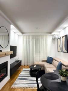 a living room with a couch and a table at Stan na dan Bogdan Ub in Ub