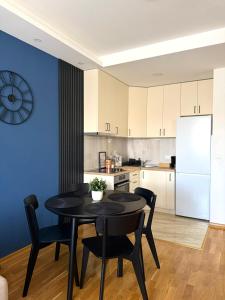 a kitchen with a table and chairs and a refrigerator at Stan na dan Bogdan Ub in Ub