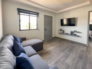 a living room with a couch and a flat screen tv at Apt Four A #4 in Punta Penasco New