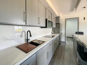 a kitchen with white cabinets and a sink in it at Apt Four A #4 in Punta Penasco New