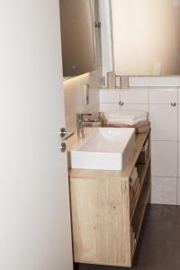 a bathroom with a white sink and a mirror at Sonnenterrasse 9 in Fischerbach
