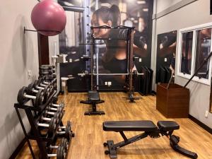 a woman in a gym with several exercise equipment at Barbosa Studios - Verbo Divino in Sao Paulo