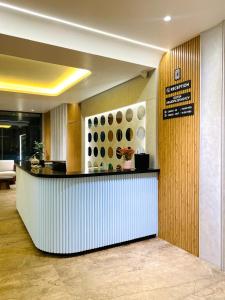 a lobby with a counter in a building at The Sapphire Hotel in Belgaum