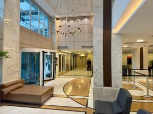a lobby with a couch and a chair in a building at Barbosa Studios - Verbo Divino in Sao Paulo +11 photos
