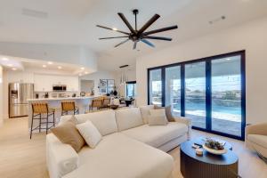 a living room with a white couch and a table at 4 Mi to Dtwn Luxe Gem with Pool in Lake Havasu City in Lake Havasu City