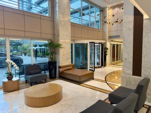a lobby of a building with chairs and a table at Barbosa Studios - Verbo Divino in Sao Paulo