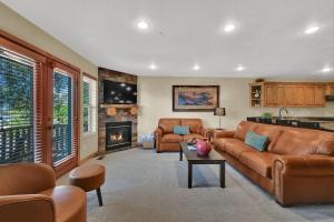 a living room with a couch and a fireplace at Eden Mountain Condo with Views Pool & Hot Tub Access in Wolf Creek Village