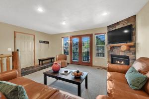 a living room with a couch and a fireplace at Eden Mountain Condo with Views Pool & Hot Tub Access in Wolf Creek Village