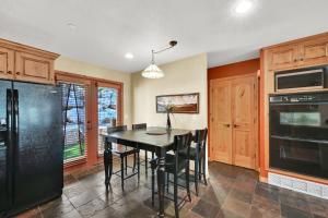 a kitchen with a black table and black appliances at Eden Mountain Condo with Views Pool & Hot Tub Access in Wolf Creek Village +37 photos