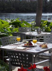 an outdoor table with wine glasses and food on it at GALLERY One - A DoubleTree Suites by Hilton Hotel in Fort Lauderdale