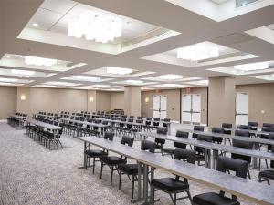 an empty lecture room with tables and chairs at GALLERY One - A DoubleTree Suites by Hilton Hotel in Fort Lauderdale +71 photos