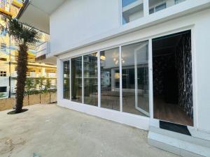 a large glass door of a building with a palm tree at Villa Palma in Tbilisi City
