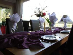 a table with a purple table cloth on a table at Hotel Haus Niggemann in Hattingen