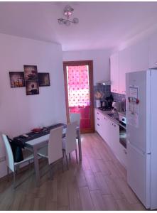 a kitchen with a table and chairs and a refrigerator at Holidays Apartment in Cagliari +15 photos